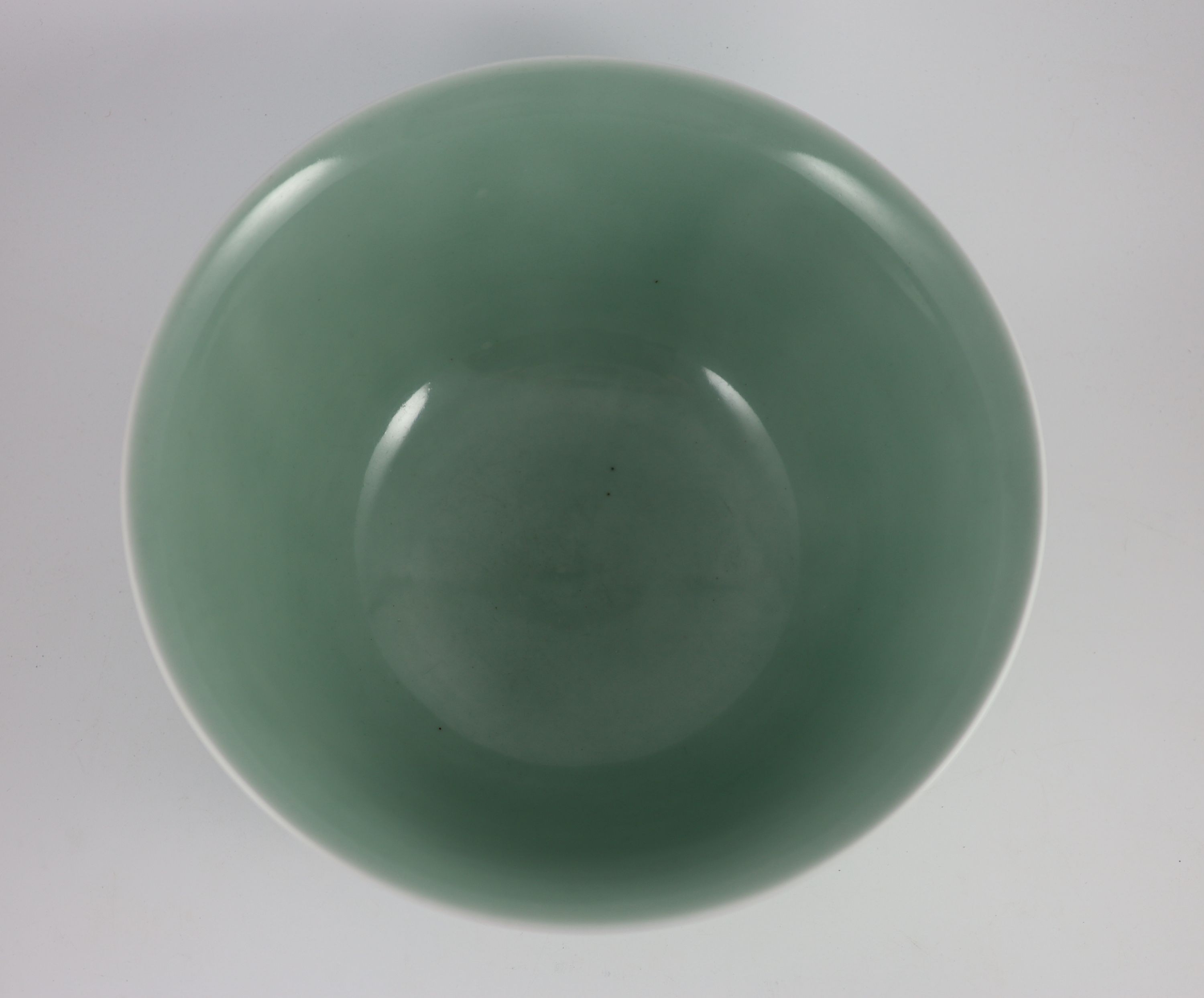 A fine large Chinese moulded celadon-glazed bowl, Qianlong seal mark and of the period (1736-95), Rim 33.6mm diameter, 16.5cm high, foot 16cm diameter